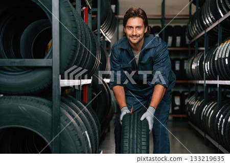 Positive facial expression. Man is in the tire fitting car service 133219635