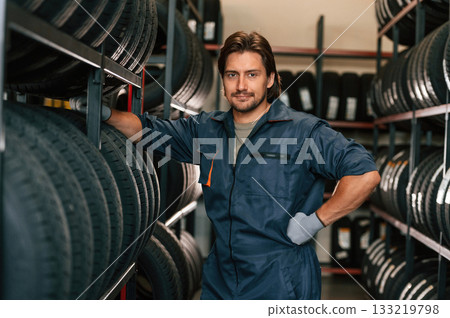 In professional uniform. Man is in the tire fitting car service 133219798