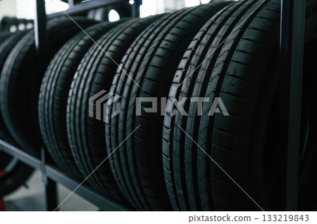 In the right order. New tires are placed on the storage rack in the car workshop 133219843