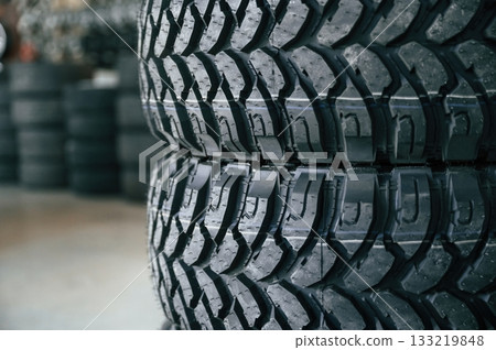 New tires are placed on the storage rack in the car workshop New tires are placed on the storage rack in the car workshop 133219848
