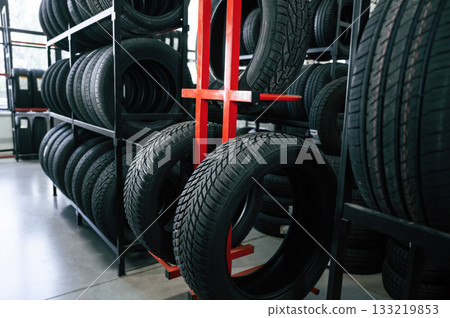 New tires are placed on the storage rack in the car workshop 133219853