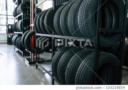 New tires are placed on the storage rack in the car workshop 133219854