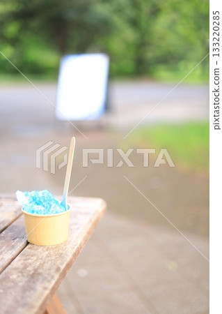 Blue Hawaii shaved ice on a park bench Blue Hawaii shaved ice on a park bench 133220285