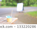 Blue Hawaii shaved ice on a park bench 133220286