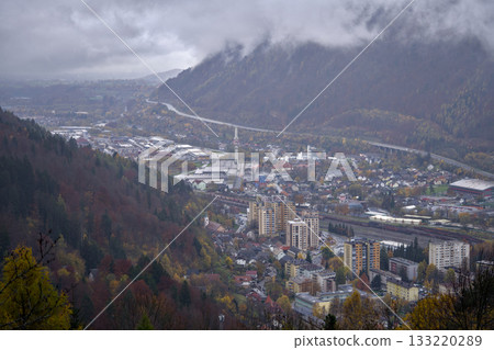 quiet town nestled among colorful mountains, majestic valley under overcast sky with peaceful river quiet town nestled among colorful mountains, majestic valley under overcast sky with peaceful river 133220289