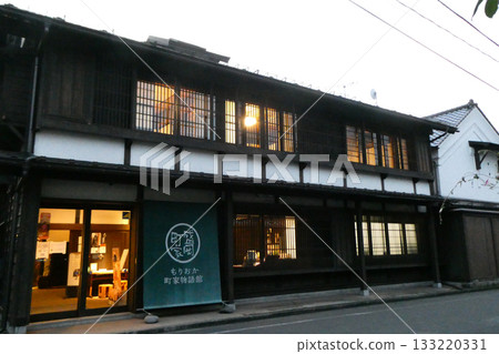 An evening view of a townhouse that seems to have slipped back in time An evening view of a townhouse that seems to have slipped back in time 133220331