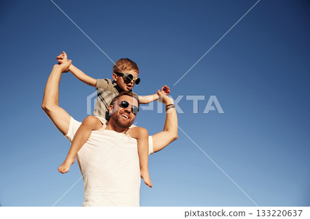 Blue sky, imagination of piloting. Father and son are together on the field Blue sky, imagination of piloting. Father and son are together on the field 133220637