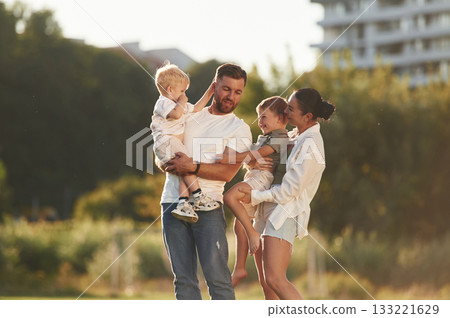Husband and wife. Parents with two little sons are on the field together Husband and wife. Parents with two little sons are on the field together 133221629