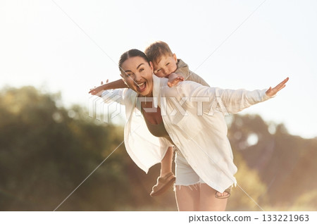 Woman with her little son are on the field together 133221963