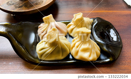 Khinkali with meat and mushroom filling served  133222034