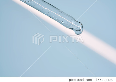 A serum pipette with lots of bubbles on a blue background. A serum pipette with lots of bubbles on a blue background. 133222480