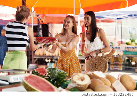 Red fresh watermelon. Two women are together on the marker or bazaar 133222495