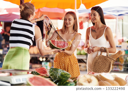 Fresh watermelon. Two women are together on the marker or bazaar Fresh watermelon. Two women are together on the marker or bazaar 133222498