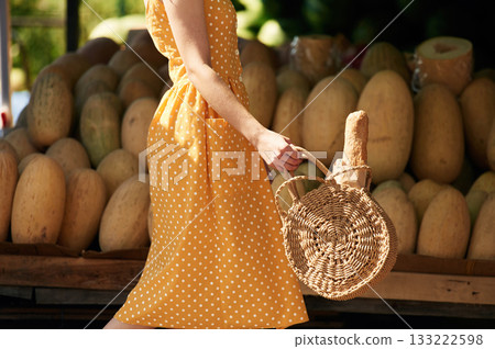 Focused close up view. Young woman is on the vegetable market or bazaar Focused close up view. Young woman is on the vegetable market or bazaar 133222598