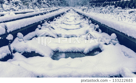 Icy winter setting showcasing unique tracks and bright blue shades Icy winter setting showcasing unique tracks and bright blue shades 133222683