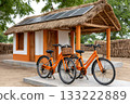 Solar powered rural hut with bright orange bicycles 133222889