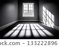 Sunlight casting geometric shadows in empty room 133222896