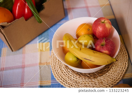 Fruit Bowl With Bananas Apples Oranges And Pears On Plaid Tablecloth In Kitchen Scene Fruit Bowl With Bananas Apples Oranges And Pears On Plaid Tablecloth In Kitchen Scene 133223245