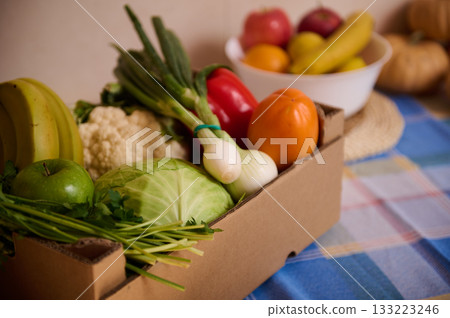 Fresh Produce Box With Vegetables And Fruits On Kitchen Table 133223246
