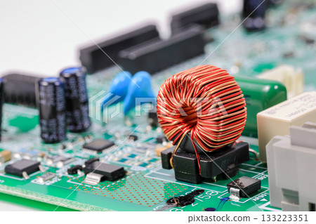 Copper coil or toroidal inductor or Inductance coil on circuit board, electronic components inside electronic equipment. 133223351