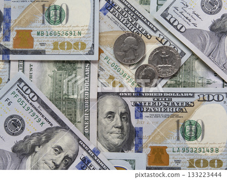 Hundred-dollar bills and some coins as background. Hundred-dollar bills and some coins as background. 133223444