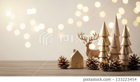 Christmas decor featuring golden miniature wooden trees, a reindeer, and a house against a soft bokeh background. 133223454
