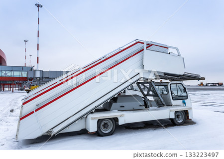 Empty passenger boarding stairs at the winter airport Empty passenger boarding stairs at the winter airport 133223497