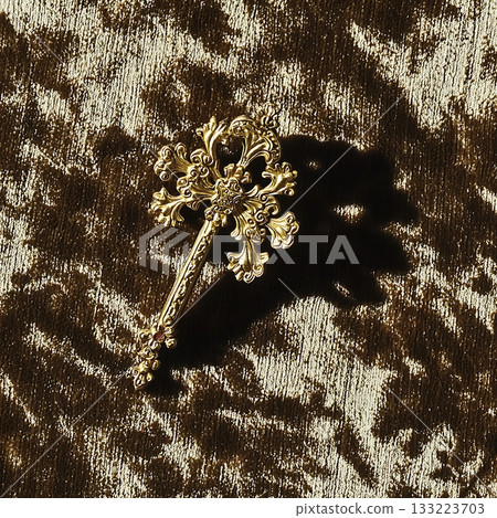 Gold cross pendant is sitting on a brown background 133223703
