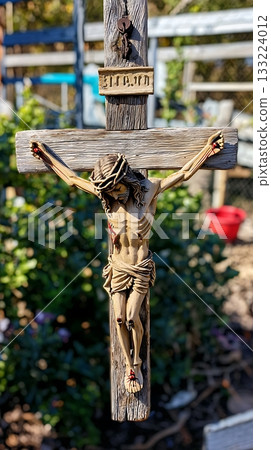 Wooden cross with a man on it, the man is Jesus Christ 133224012