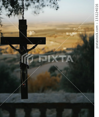 Crucifix is hanging from a tree 133224016