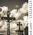 Cross with a statue of Jesus Christ holding it 133224133