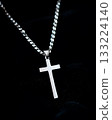 Silver cross pendant is displayed on a black background 133224140