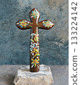 Wooden cross with flowers painted on it 133224142