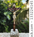Wooden cross with a man holding it up 133224145