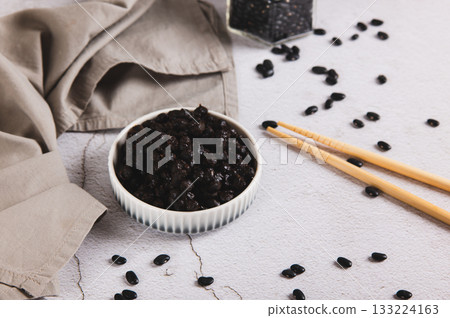 Asian fermented black beans on a plate on the table 133224163