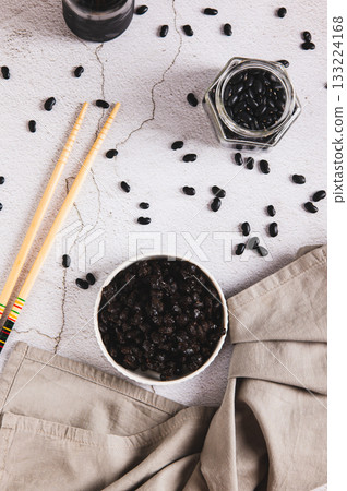 Asian fermented black beans on a plate on the table top and vertical view Asian fermented black beans on a plate on the table top and vertical view 133224168