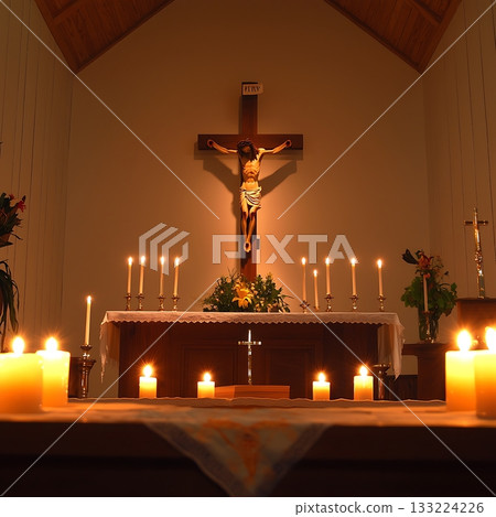 Lit candle in a church with a cross on the wall Lit candle in a church with a cross on the wall 133224226