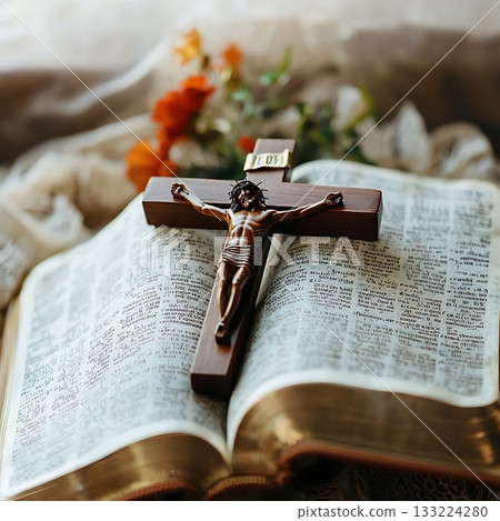 Wooden cross is on top of a Bible, with a flowery background Wooden cross is on top of a Bible, with a flowery background 133224280