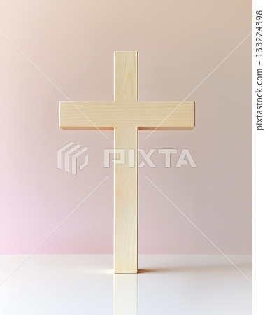 Wooden cross is standing upright on a white table 133224398