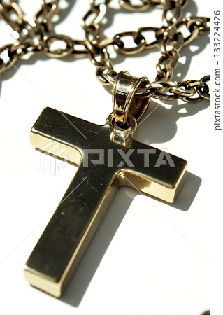 Gold cross pendant with a T on it 133224426