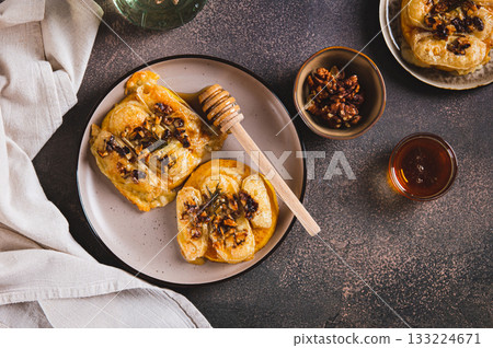 Baked pumpkin with brie cheese, nuts, rosemary and honey on a plate on the table top view 133224671