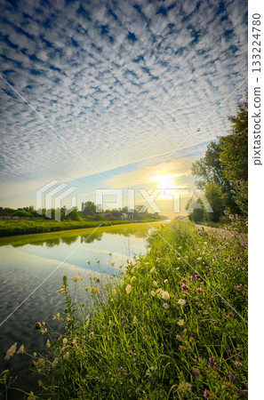 Experience a Serene Sunrise Over a Beautiful Reflective River Nestled in Natures Embrace Experience a Serene Sunrise Over a Beautiful Reflective River Nestled in Natures Embrace 133224780