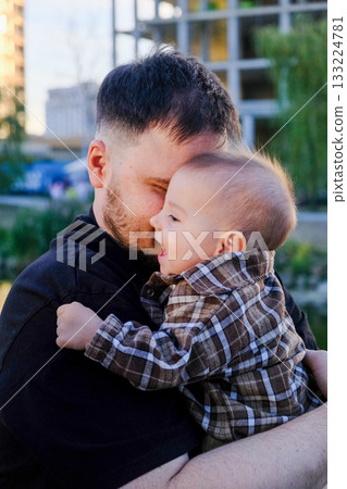 Father and Baby Smiling Outdoors 133224781