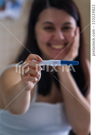 Surprised Woman with Positive Pregnancy Test Surprised Woman with Positive Pregnancy Test 133224822