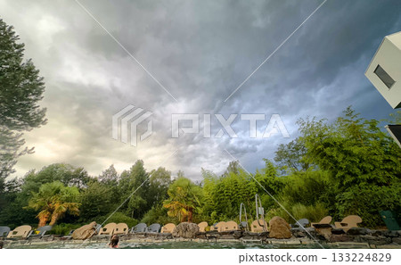Dramatic and Majestic Clouds Ascend Gracefully Over the Scenic and Beautiful Outdoor Landscape Below 133224829