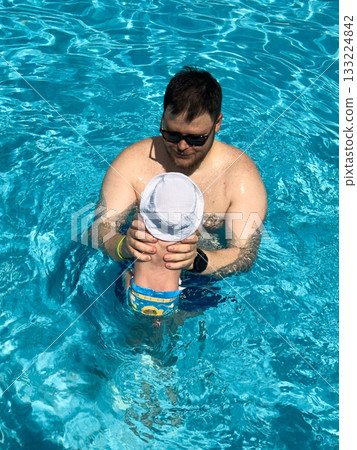 Father and Baby Enjoying Pool Time 133224842