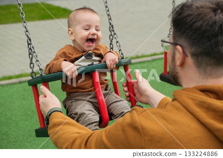 Father and Baby Enjoying Swing Time 133224886