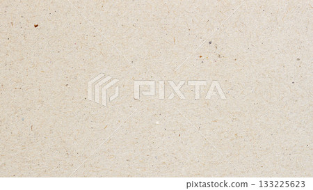 Macro of beige recycled craft paper with natural fiber and small colorful inclusions. Natural background for eco design, packaging or sustainable texture, copy space Macro of beige recycled craft paper with natural fiber and small colorful inclusions. Natural background for eco design, packaging or sustainable texture, copy space 133225623