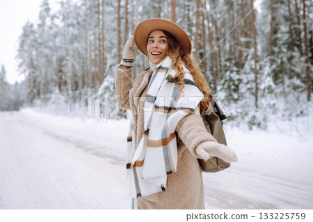 Beautiful woman posing in winter forest. Great winter weather and atmosphere. Christmas. Beautiful woman posing in winter forest. Great winter weather and atmosphere. Christmas. 133225759