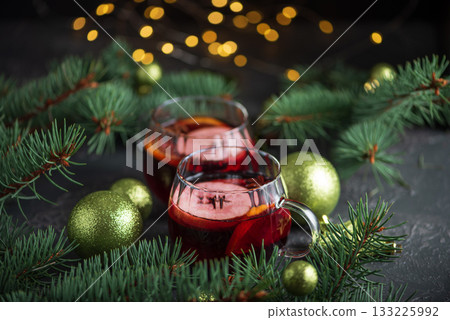 Two Glass Mugs of Mulled Wine with Christmas Decor and Fairy Lights 133225992